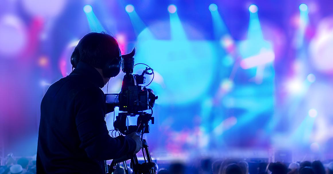 Kuvaaja kuvaa konserttia videokameralla (Kuva: Shutterstock)