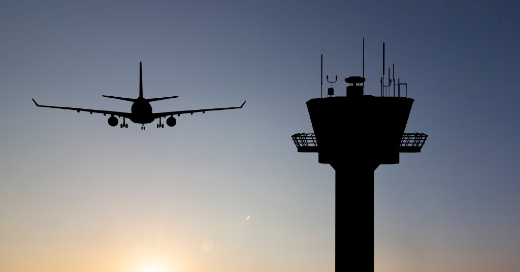Airplane and an air traffic control tower (Photo: Shutterstock)