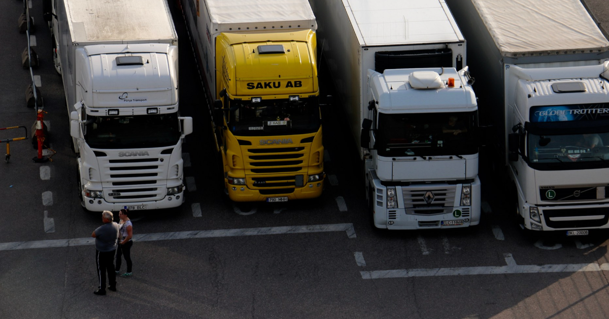 Trucks in the harbor, two people standing next to the trucks. (Photo: Shutterstock)
