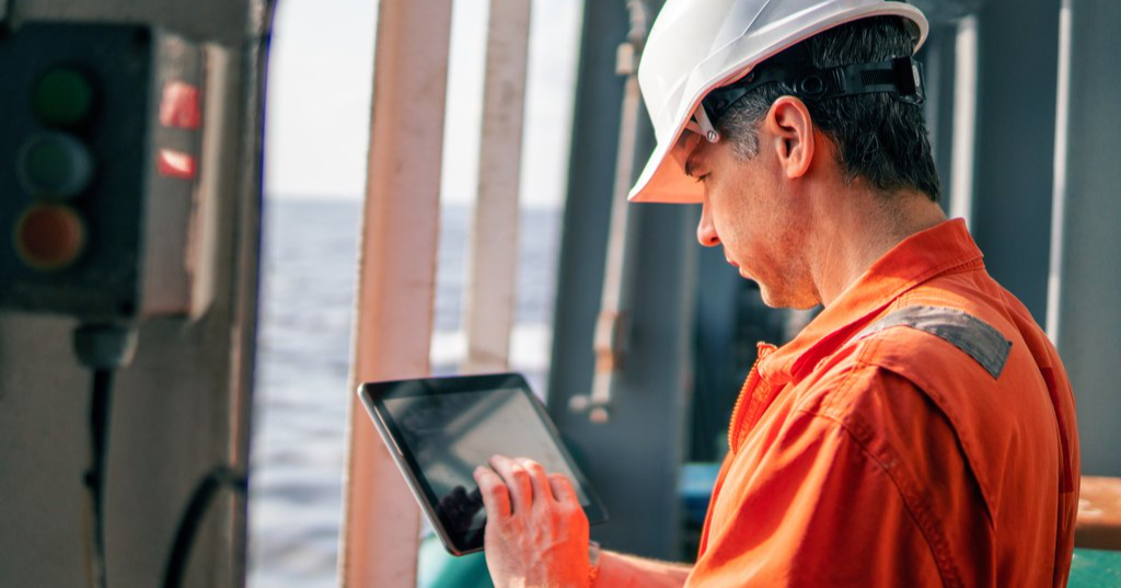 A man using a tablet on board a ship. (Photo: Shutterstock)